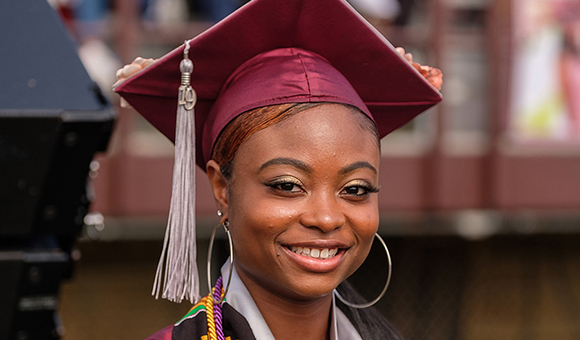 NCCU student at graduate smiling at the camera.