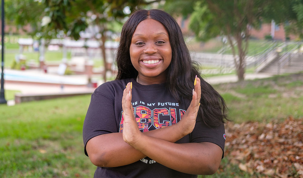 student doing the eagle hand signal