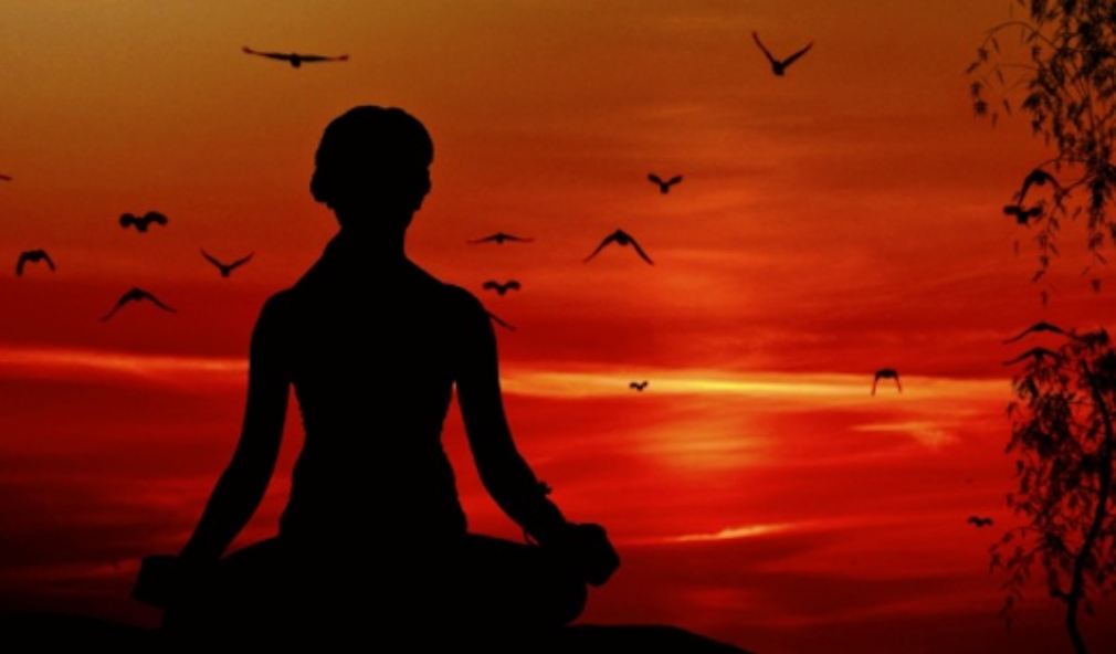 Image of a person sitting during sunset