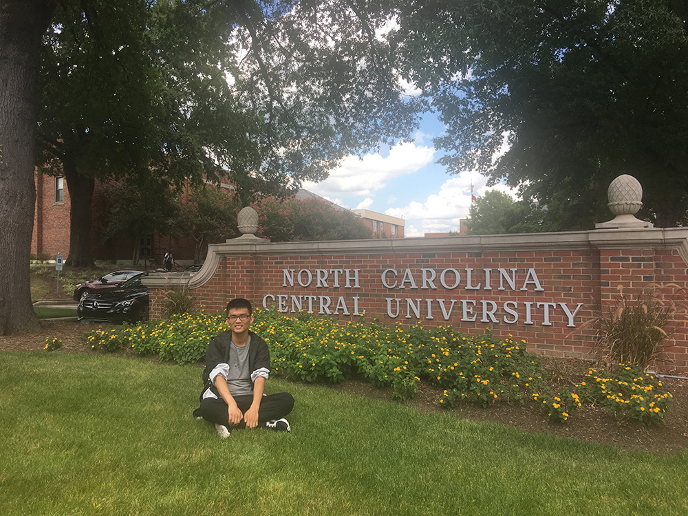 Student seating in front of NCCU entrance