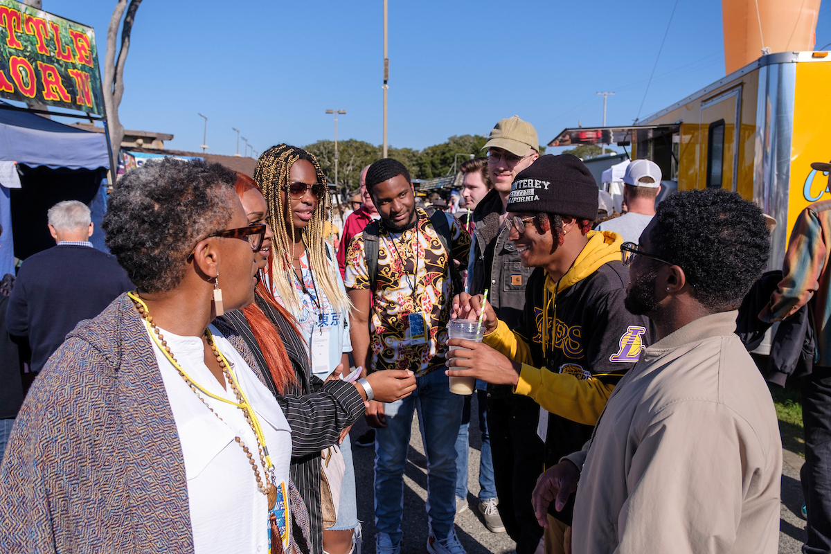 Several black adults enjoying a jazz festival