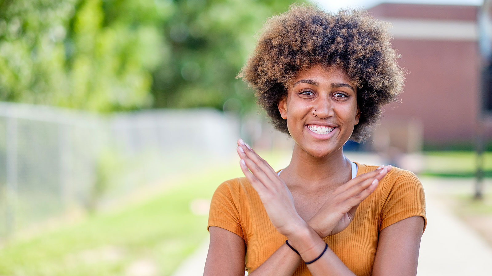 student doing the nccu eagle sign