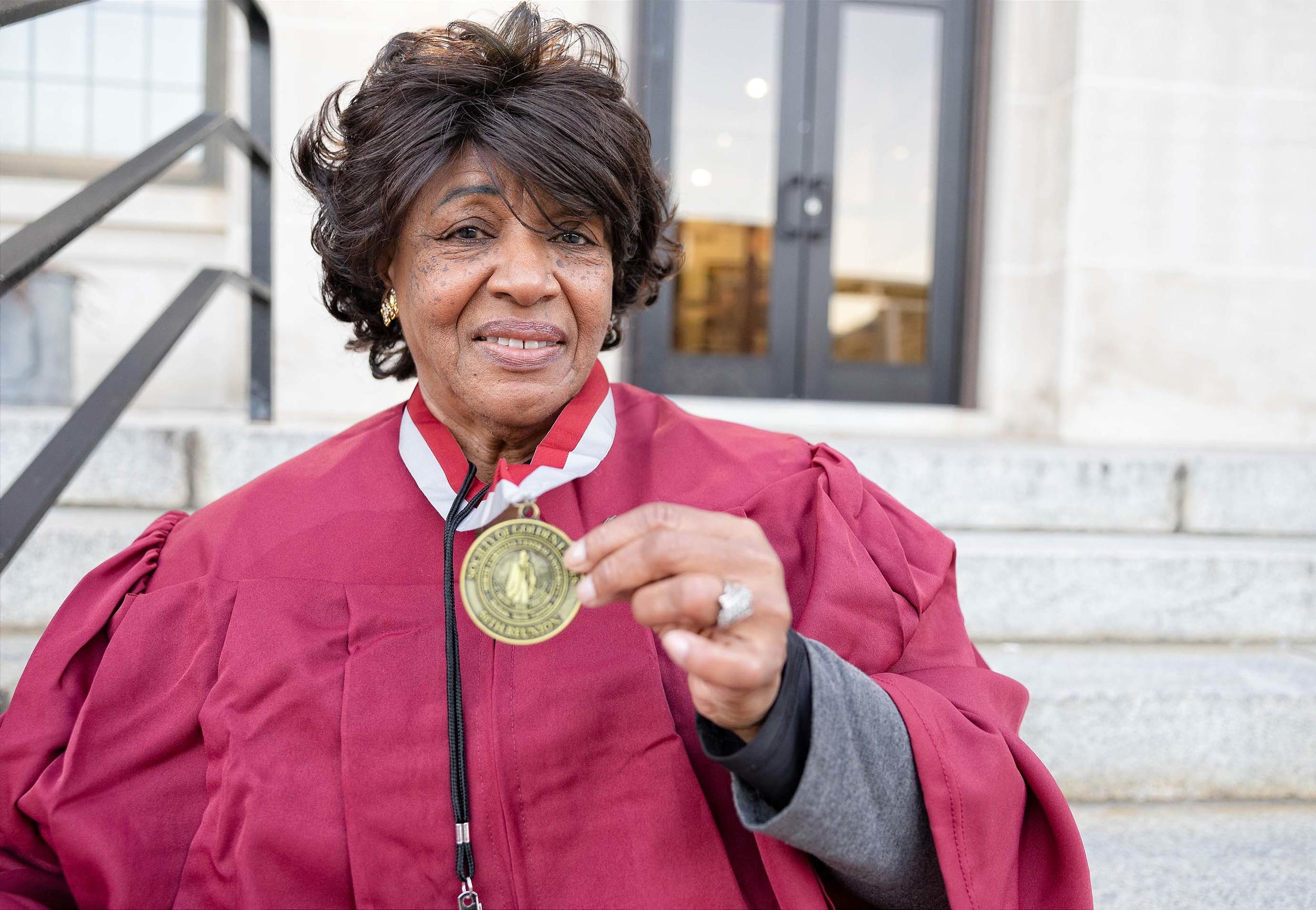 An image of a NCCU alum holding a medal