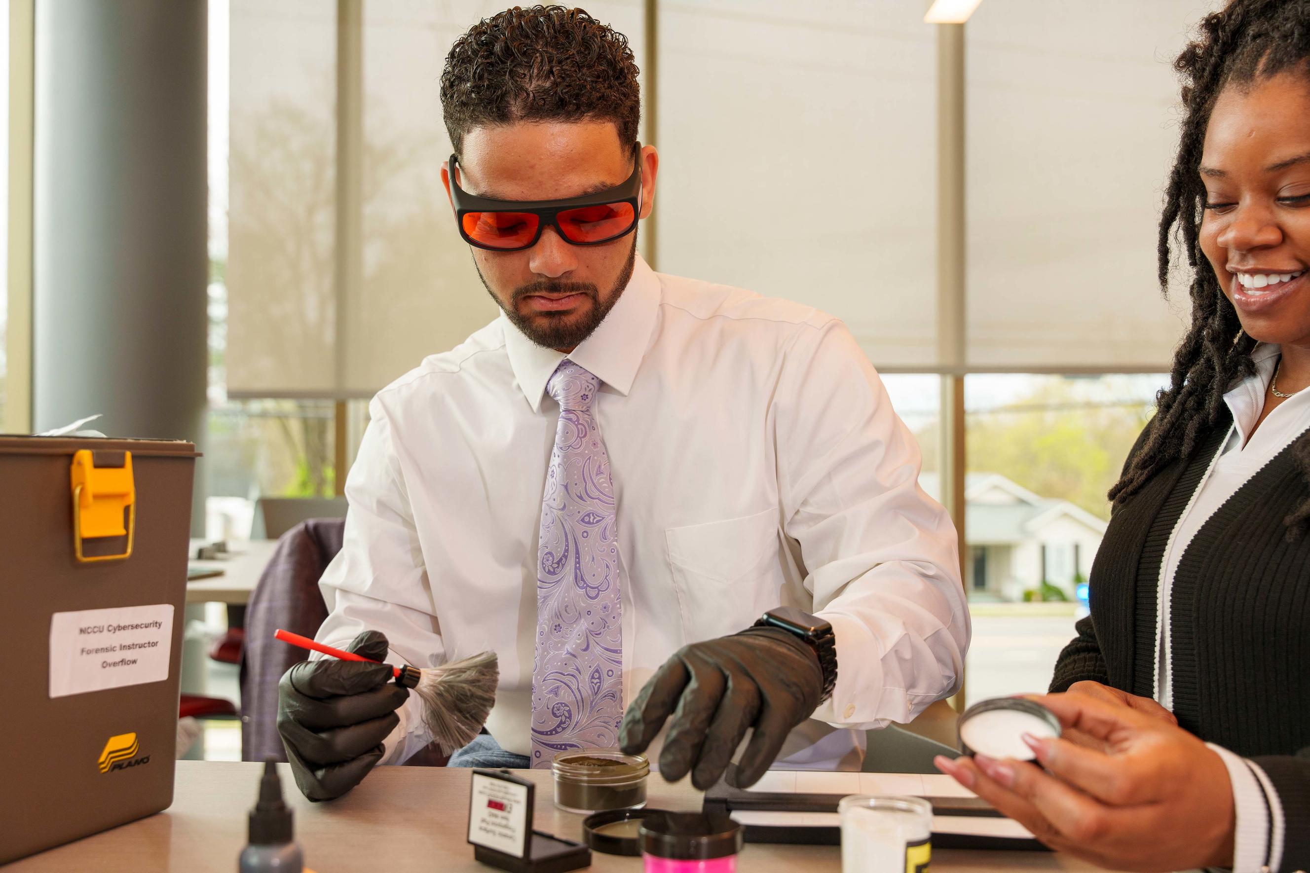 Two adults doing forensic work in a lab