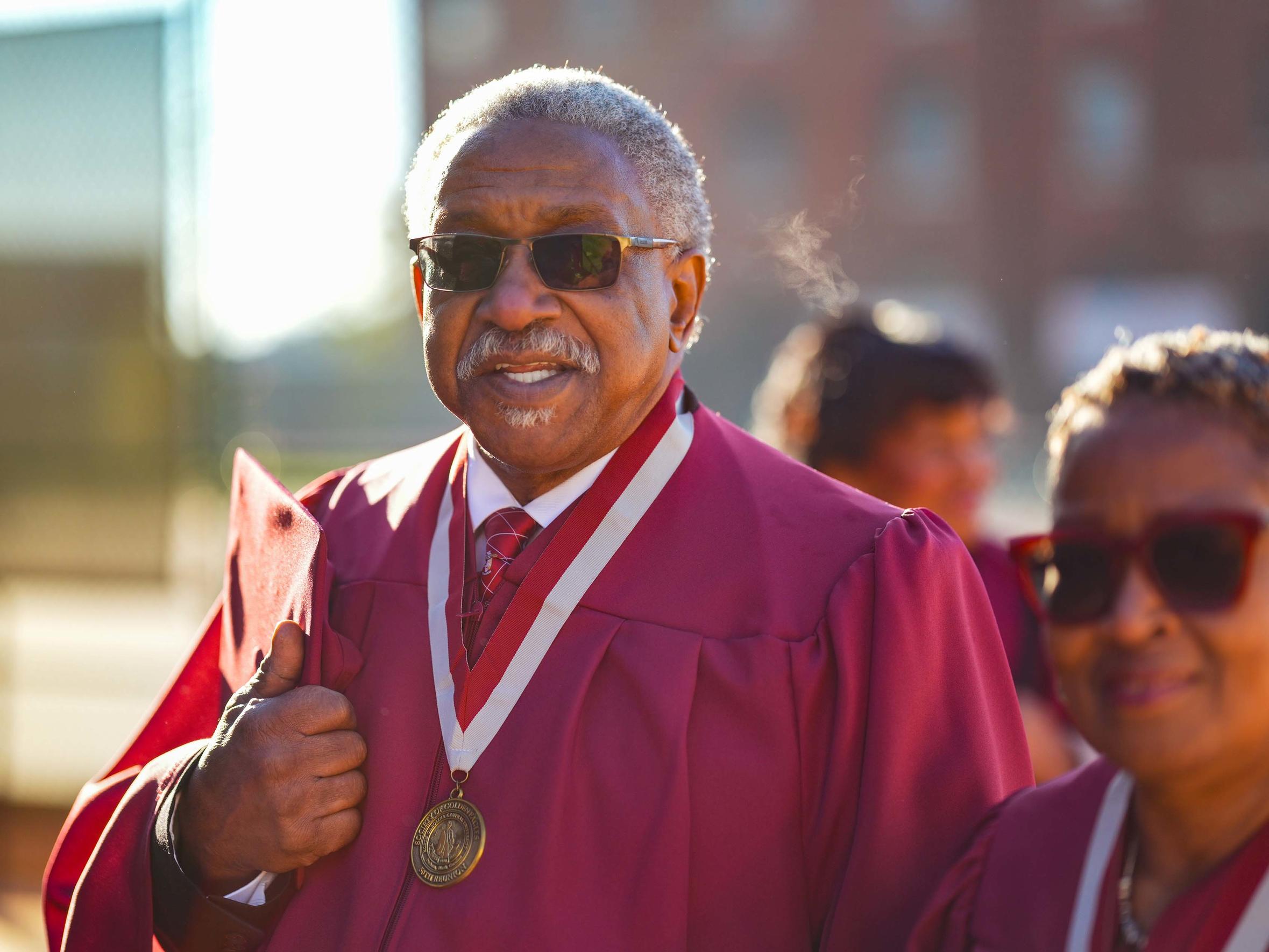 Alumni in robes posing at an event