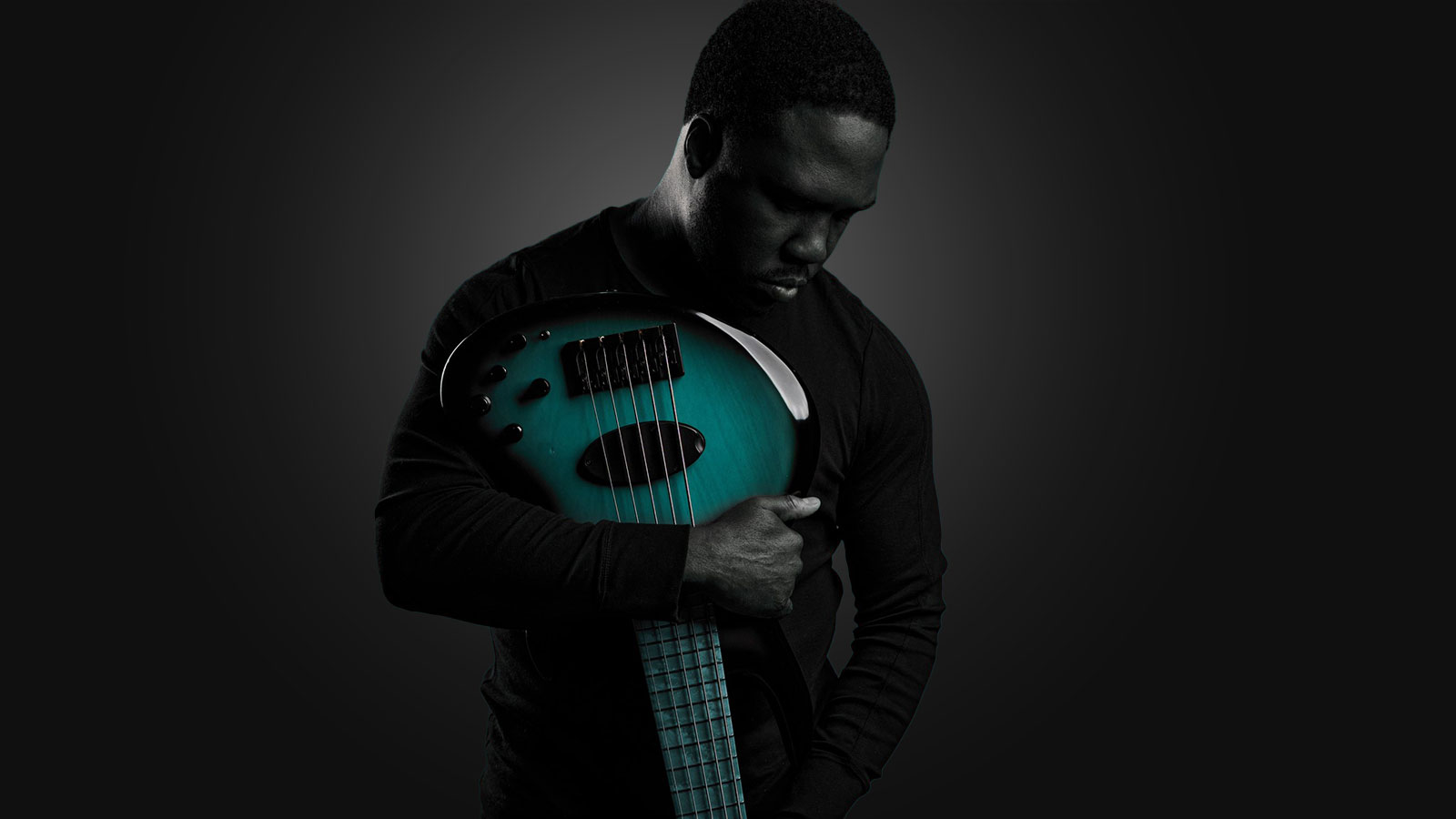 Derrick Hodges holding a Bass