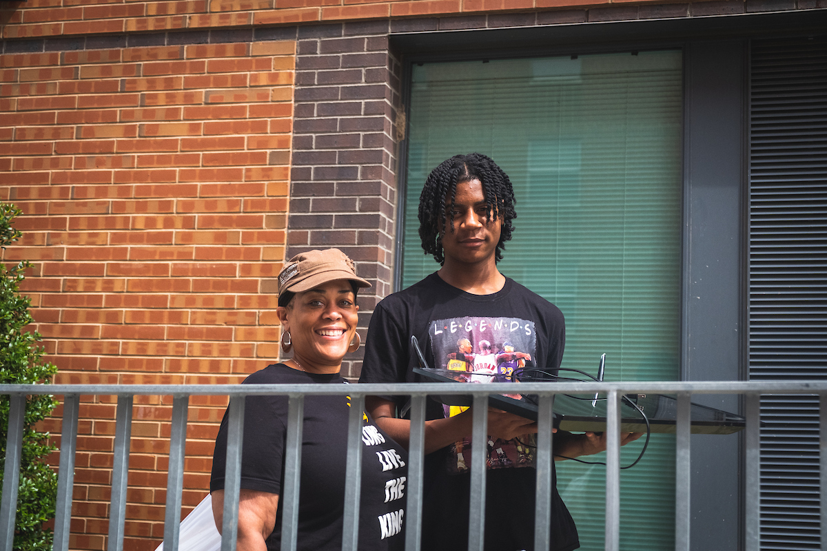 A parent helping a student move in