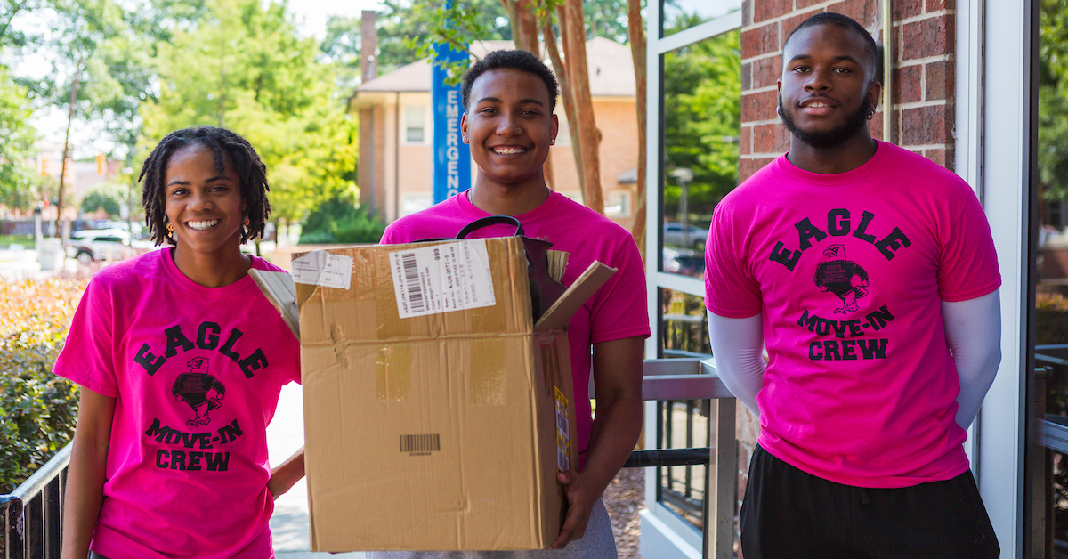 Eagle move-in crew holding a box