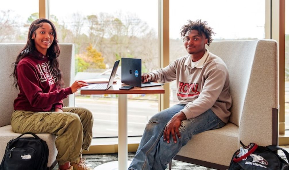 two students with laptops