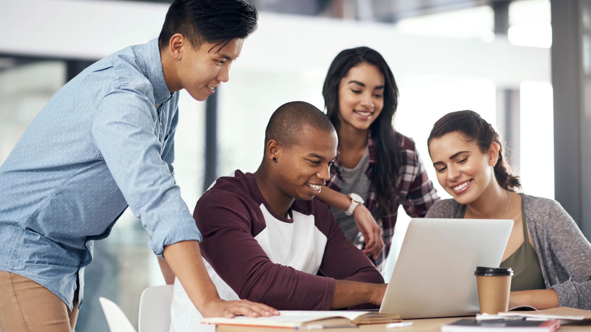 people gathered around laptop