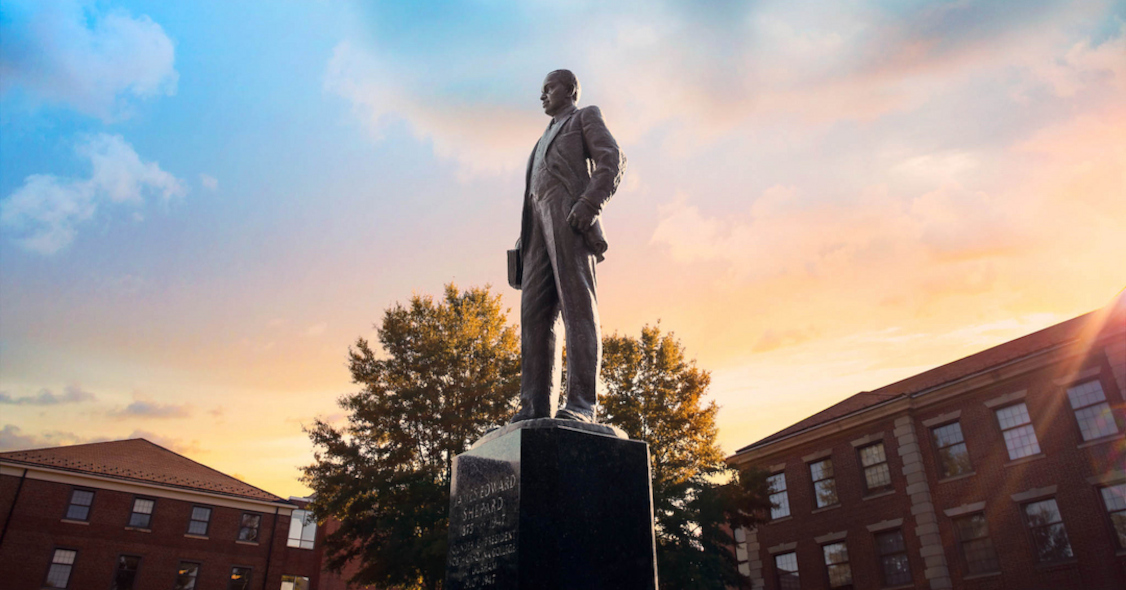 Shepard statue outside of NCCU with the sunset in the background