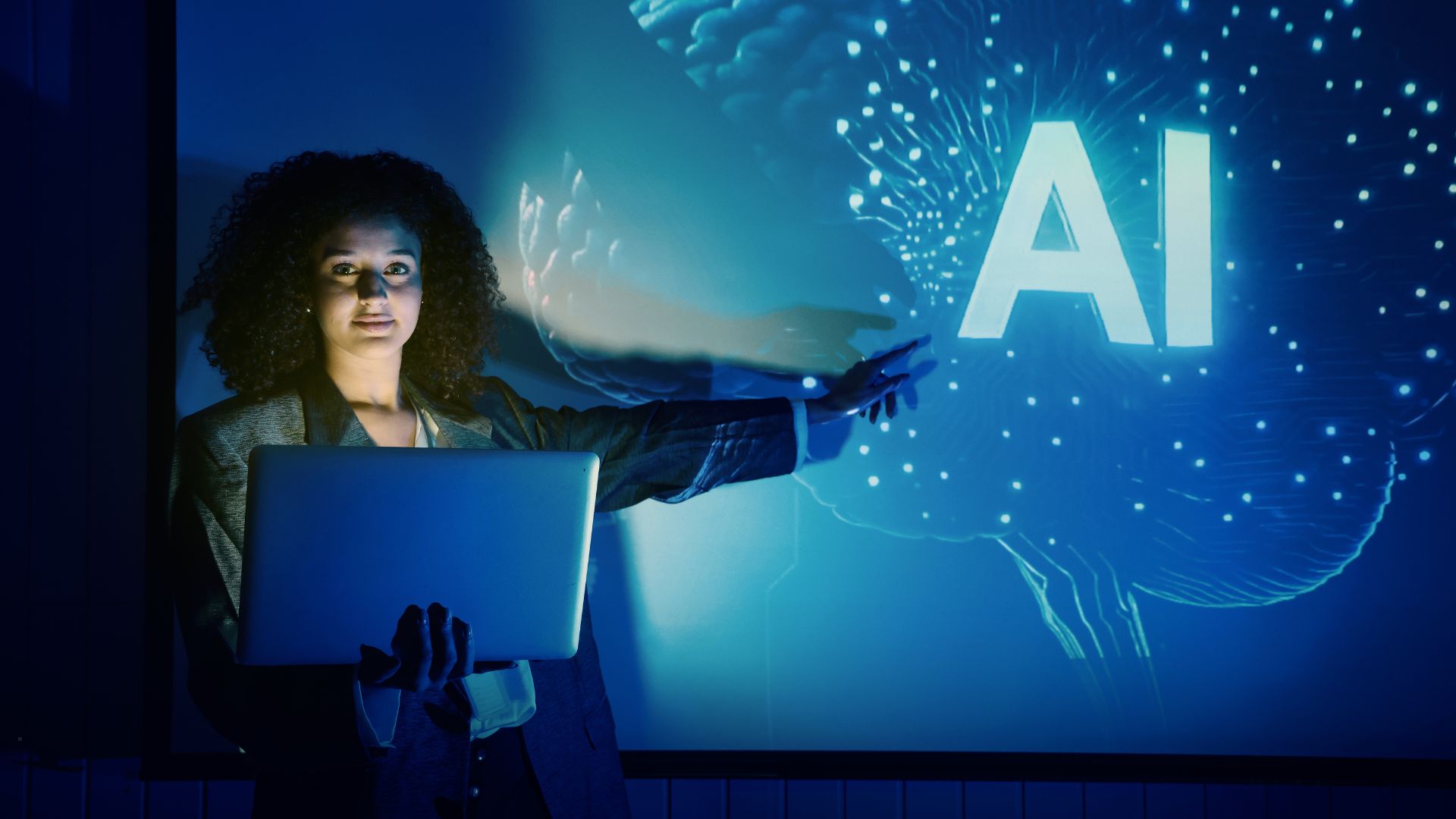 Lady wit laptop pointing at AI