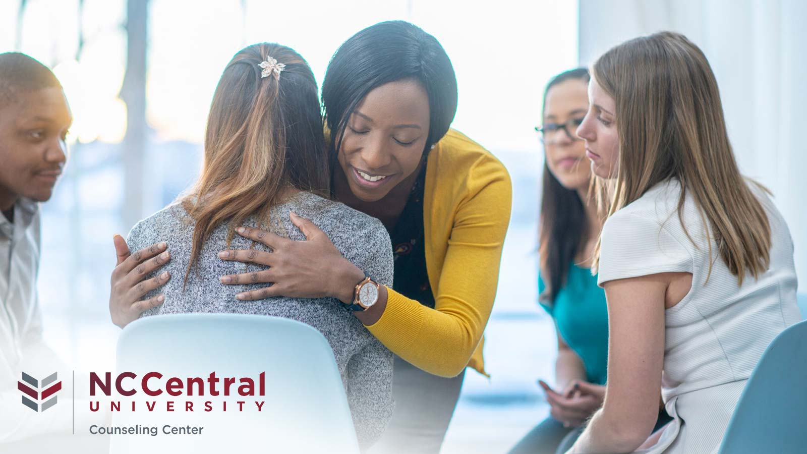 A group of supportive peers comforts a student in a therapy circle, featured on a promotional graphic for the NCCentral University Counseling Center.