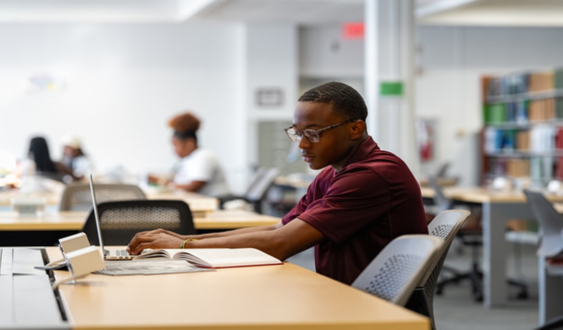 Image of man sitting at desk studying