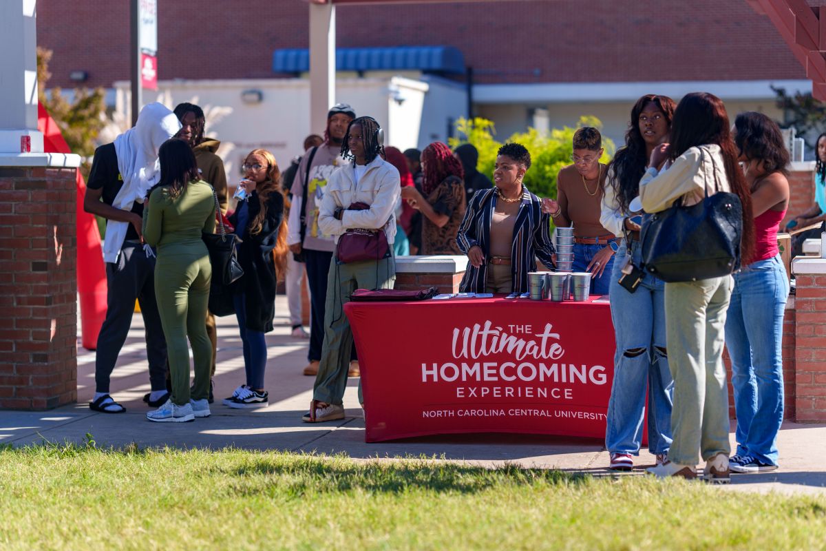 group of people gathering around a booth