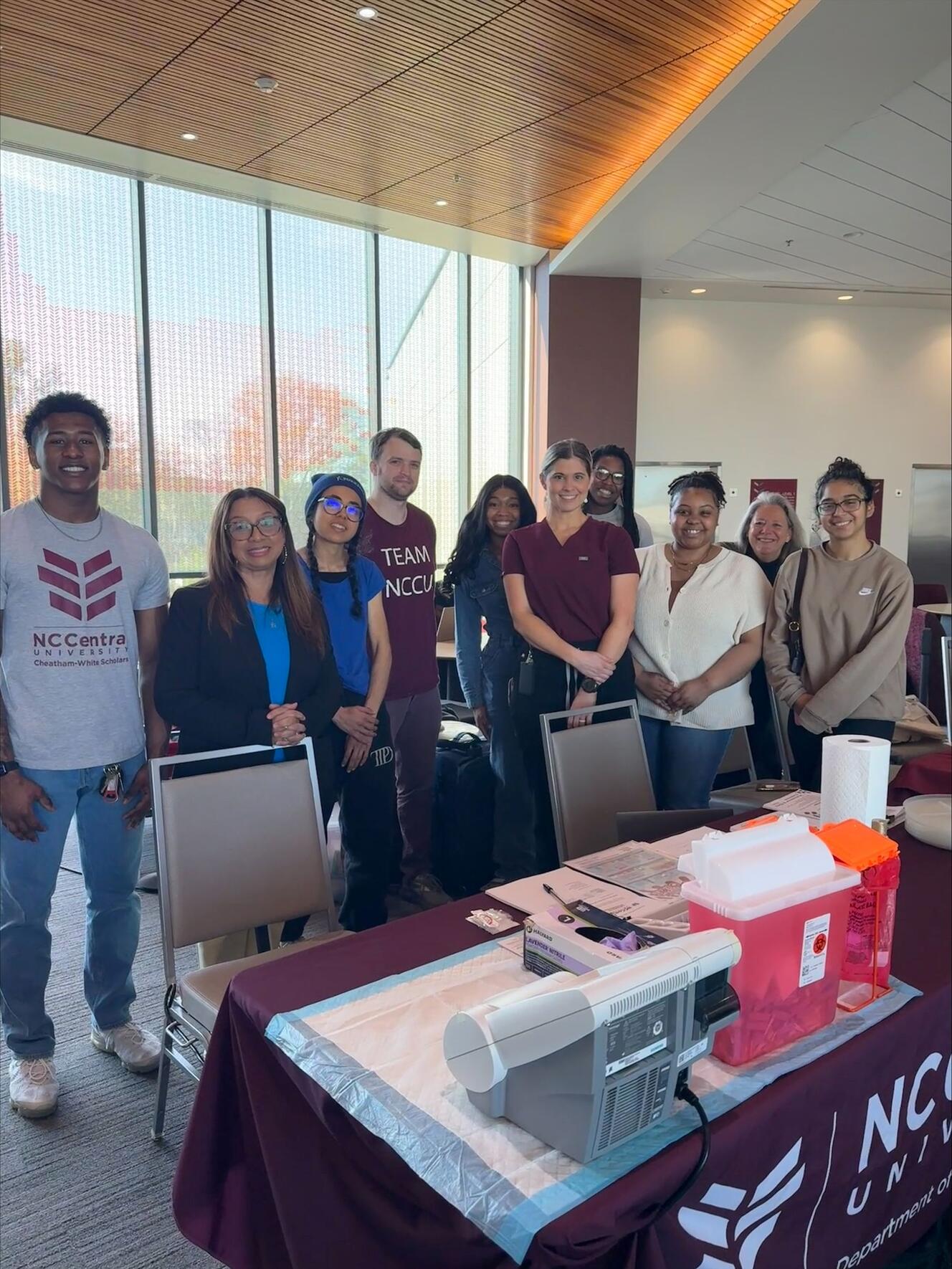 Group of people standing behind a table