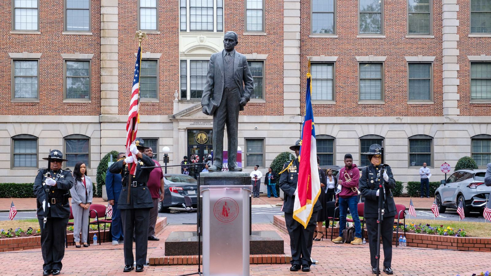North Carolina Central University color guard presents the American and North Carolina flags during a Veterans Day ceremony in front of the James E. Shepard statue on campus.