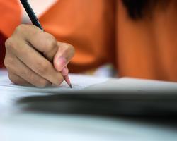 Student is taking survey on paper with pencil