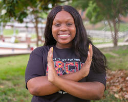 student doing the eagle hand signal