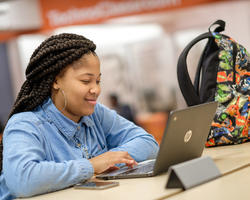 Woman Smiling at Computer