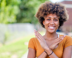 student doing the nccu eagle sign