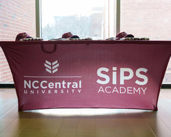 Table with SiPS Academy Banner