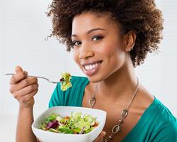 person eating a salad with a fork