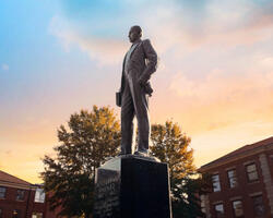 Shepard statue outside of NCCU with the sunset in the background