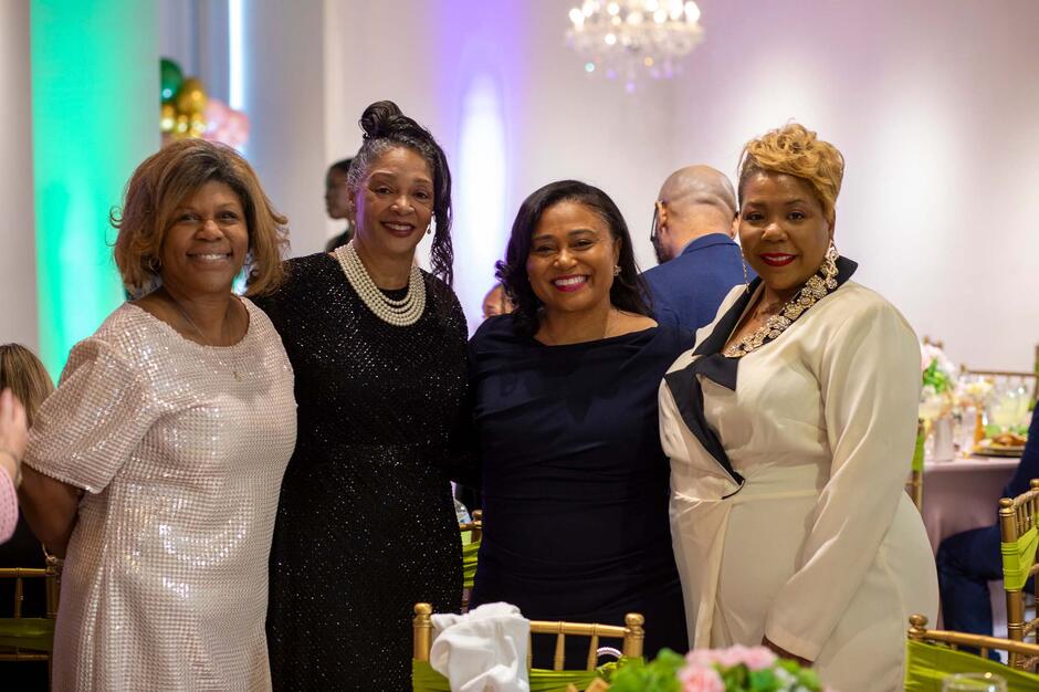 four people at a gala event