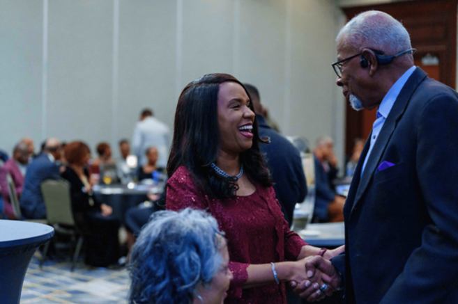 Photo of two people shaking hands at a nccu reception.
