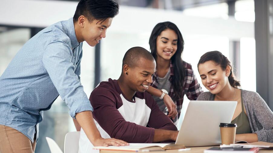people gathered around laptop