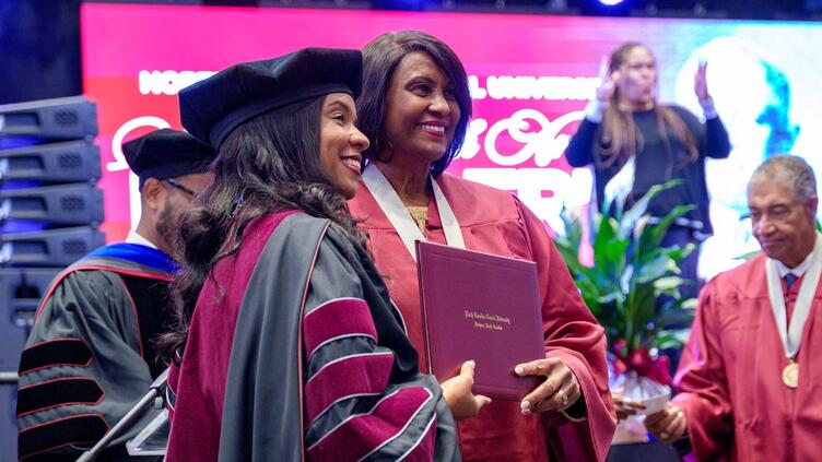 two people holding award at founder's day