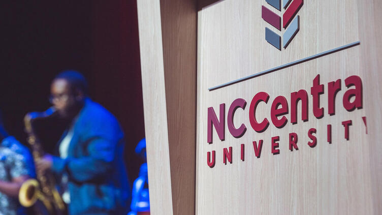 NCCU logo with a man playing a saxophone in the background