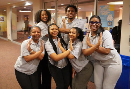 students making eagle hand signs