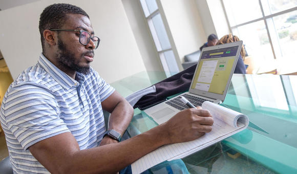 Student taking survey on laptop