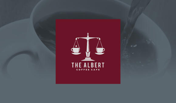 The Albert Coffee Café logo with an image of coffee being poured behind