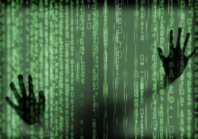 A pair of hands pressed against a screen with green writing