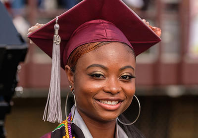 NCCU student at graduate smiling at the camera.