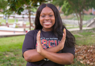 student doing the eagle hand signal