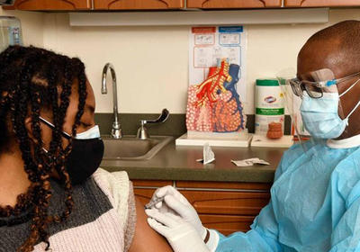 A doctor administering a vaccine.