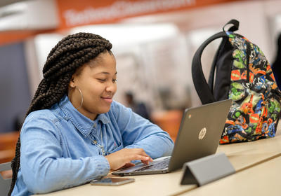 Woman Smiling at Computer