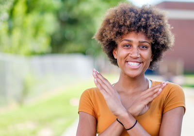 student doing the nccu eagle sign