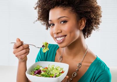 person eating a salad with a fork